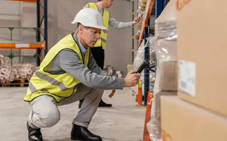 Warehouse workers working safely wearing PPE after IOSH course