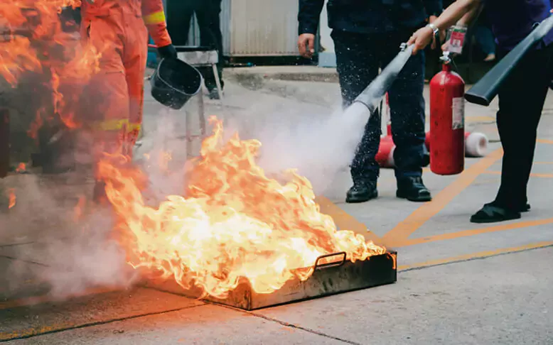 NEBOSH Fire Saftey Trained individual defusing a fire