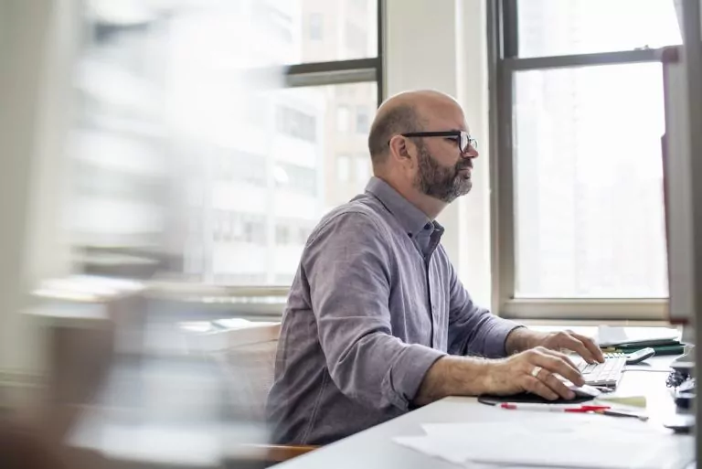 man taking asbestos awareness course online